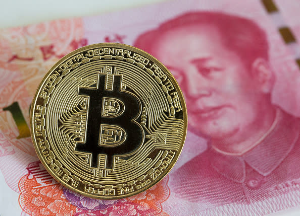 Bruised by stock market, Chinese rush into banned bitcoin | Reuters